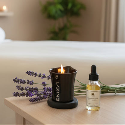 Relaxing candle and bottle of essential oil with lavender flowers on a wooden surface